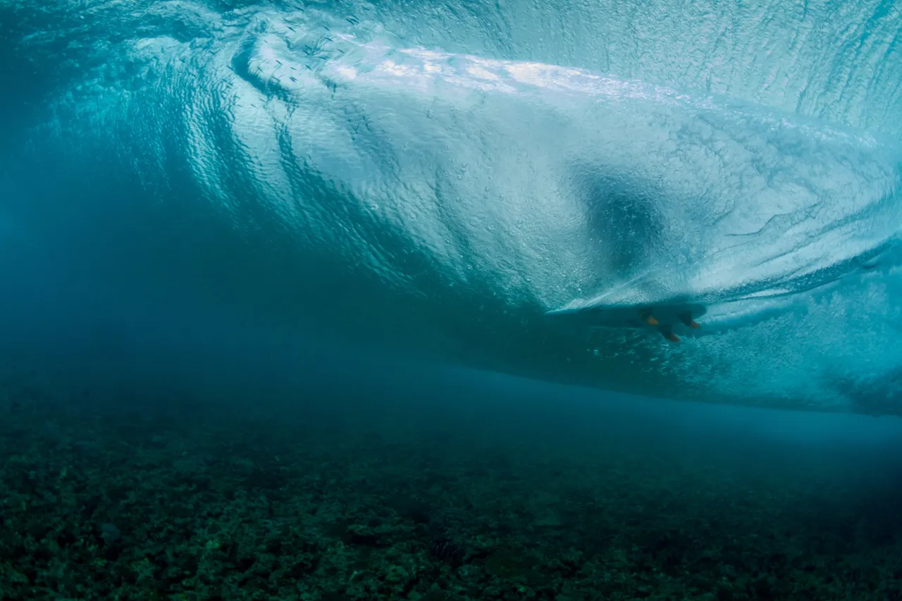 A wave seen from below the surface, light passing through the water.
